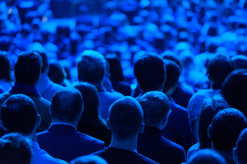Audience listens to the lecturer at the conference hall