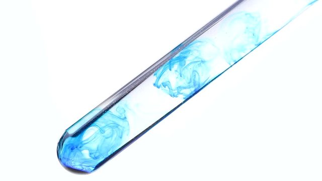 Glass test tube in laboratory with blue color ink inside. Close up macro.