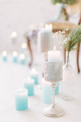 Blue candles, candles in the silver candlesticks and the vintage chair on the floor.