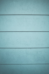 Obraz premium Blue coloured design wall on wood texture / Horizontal lines on blue pastel empty panels. Texture made of blue wood strips. Graphic resource. Space for text.