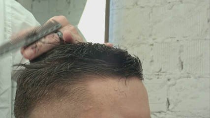 Obraz na płótnie Canvas Men's haircut at the barber scissors