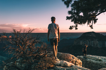 young man admires the Magnificent Grand Canyon, Arizona, USA.