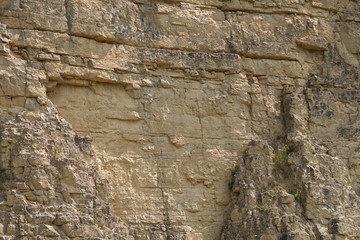impressive huge steep wall in a surface quarry, stone texture, can be used as background