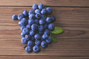 natural blueberries in rustic wood bottom