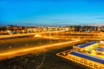 ring road in St. Petersburg at white night, new buildings and high-voltage power lines