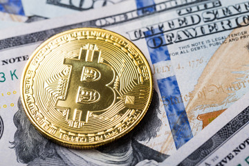 Bitcoins on dollar banknotes background