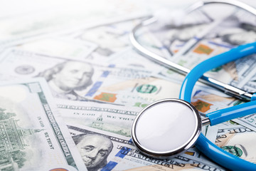 Stethoscope on dollar banknotes background