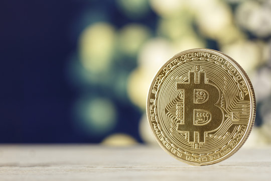 The golden bitcoin on marble table and bokeh background, golden bitcoin symbol of bitcoin crytocurrency from blockchain technology.