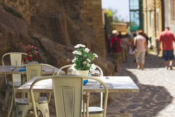 Set tables in a street restaurant at Sardegna, Italy