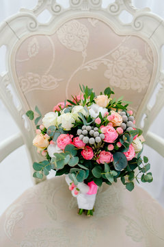 beautiful rich bouquet of the bride. Summer wedding. photo shoot in the studio. rare flowers in a composition on a velvet armchair