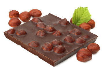chocolate with hazelnuts and leaves isolated on white background