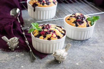 Small berry pies in a ceramic baking dish.