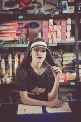 Smiling saleswoman at the counter in the autoparts shop.
