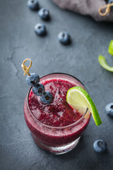 Alcohol frozen blueberry cocktail margarita with tequila and lime