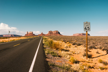  road over monument valley, USA with sign 