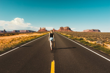 Young woman on the road over monument valley, USA