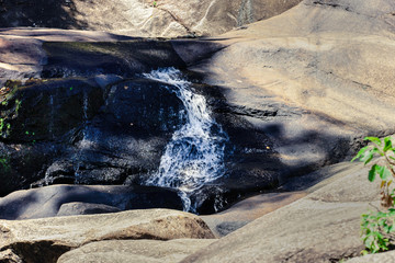 Cascading waterfall on river in the mountains in jungle in Asia