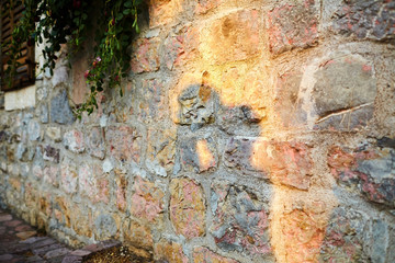 shadow of a kissing couple in love on an old stone wall