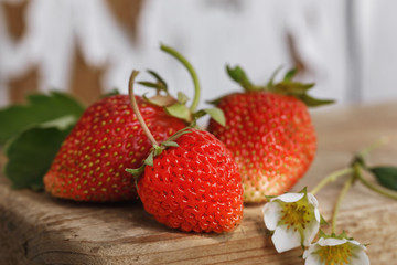 Harvesting: ripe and juicy strawberry close-up on a wooden table