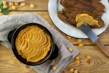 hummus with croutons on a wooden table