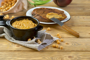 hummus with croutons on a wooden table