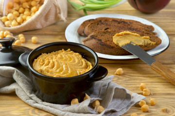 hummus with croutons on a wooden table
