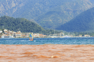 Surfing with mud (red) water and clear sea in Marmaris