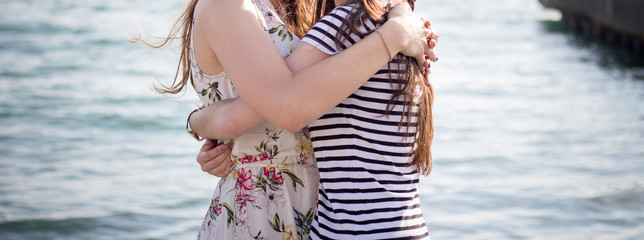 Girls hugging near the sea