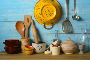 pile of kitchen utensils on light blue background - horizontal
