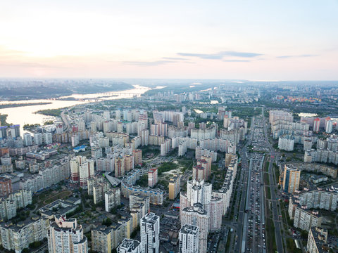 A bird's eye view, aerial panoramic view from drone to the Darnyts'kyi district of Kiev, Ukraine and view to the right bank of Dnieper at sunset in the summer. © artjazz
