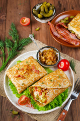 Savory pancakes stuffed with mashed potatoes, pickles and bacon