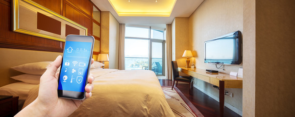 mobile phone with smart home app in modern bed room