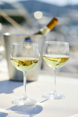 Pair of wineglasses against the yacht