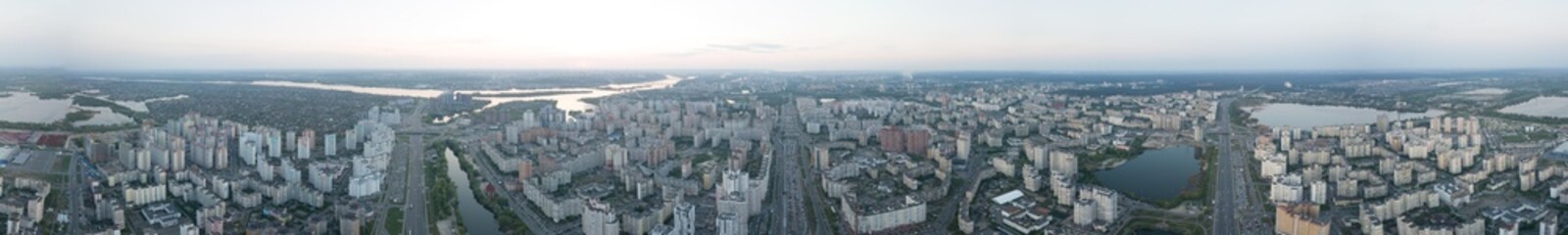 Naklejka na ściany i meble A bird's eye view, aerial panoramic view from drone to the Darnyts'kyi district of Kiev, Ukraine and the left bank of Dnieper.