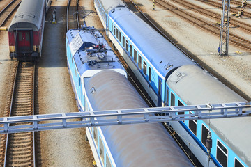 Electric locomotive and a train standing on the railroad tracks