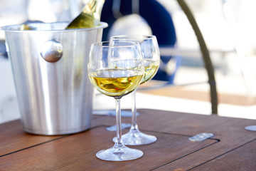 Pair of wineglasses against the yacht