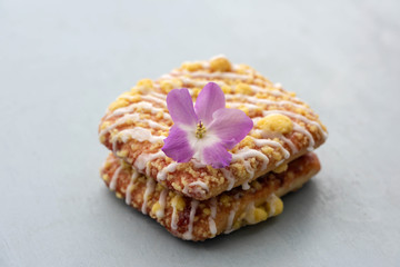 Tasty glazed dessert with a flower on top.