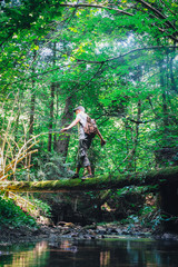 Obraz premium Alone man in wild forest. Travel and adventure concept. Landscape photography