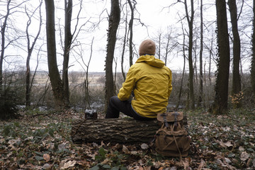 Fototapeta premium Man with backpack in wild forest. Travel and adventure concept. Landscape photography