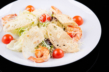 Seafood salad with shrimps, salad leaf, cherry tomato and parmesan cheese.