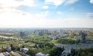 The panoramic bird's eye view shooting from drone to modern city district with urban infrastructure and residential buildings of Kiev, Ukraine at summer sunset.