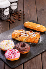 Assorted donuts with pink glazed, chocolate frosted and sprinkles