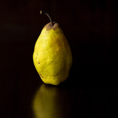 A pear against a dark background