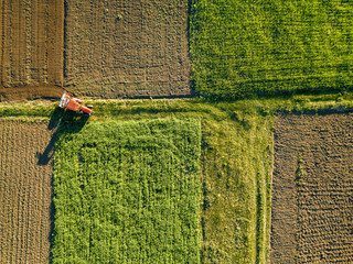 Aerial view from the drone, a bird's eye view of agricultural fields with a road through and a...