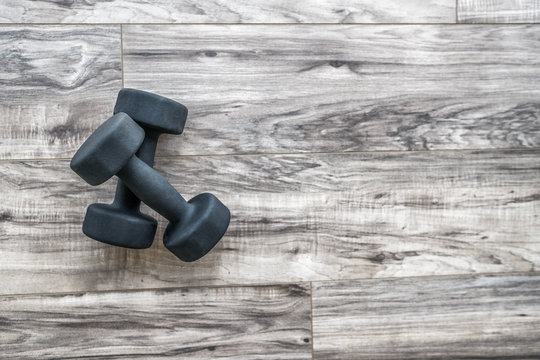 Training At Home Fitness Concept: Dumbbell Weights On Wood Floor At Fitness Gym . Weight Loss And Health. Sport Fit Lifestyle.