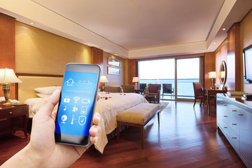 mobile phone with smart home app in modern bed room