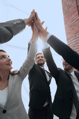 Business people with their hands together in a circle
