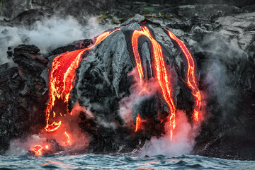 Hawaii lava flow entering the ocean on Big Island from Kilauea volcano. Volcanic eruption fissure...