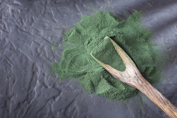 seaweed powder spirulina on wooden background