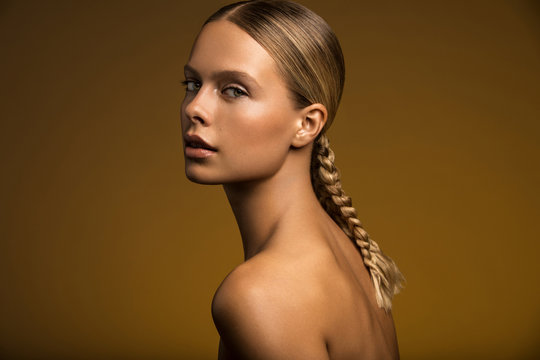 Woman with braid looking at camera
